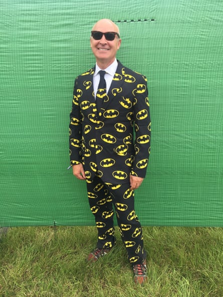Man in a suit covered in Batman logos
