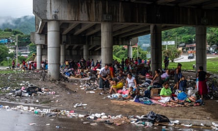 People who were forced to abandon their homes in the in the aftermath of Hurricane Eta take refuge in a makeshift camp underneath an overpass.