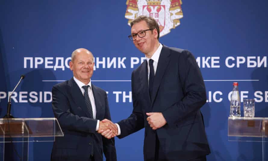 German Chancellor Olaf Scholz, left, shakes hands with Serbian President Aleksandar Vucic after a press conference at the Serbia Palace, in Belgrade, Serbia, Friday, June 10, 2022.