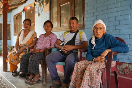 Three women and a man sit on a patio