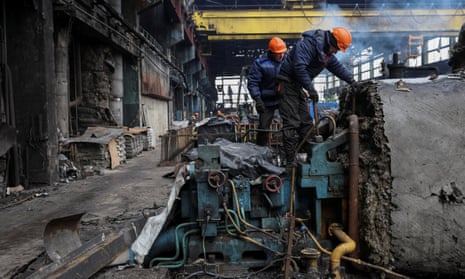 Workers fix a thermal power plant damaged by a Russian missile strike at an undisclosed location in Ukraine