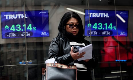 A woman looks at her phone, flanked on either side by trading data screens showing Truth Social shares are up by 43%