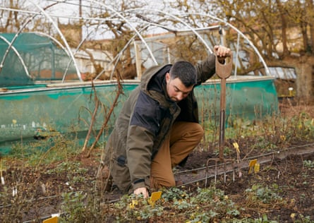 Dean Charlton tends to plants at his nursery.
