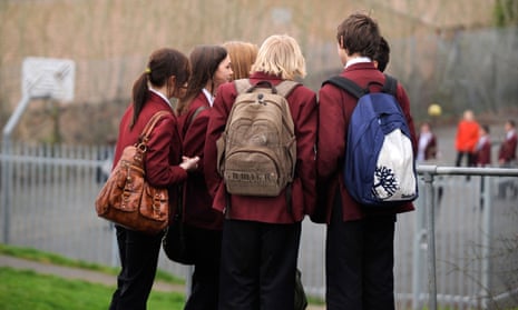 Male and female secondary school pupils in a huddle outdoors (picture posed by models)