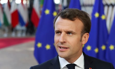 The French president, Emmanuel Macron in front of EU flags