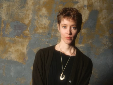 A portrait of Suzanne Vega wearing a black top and a necklace