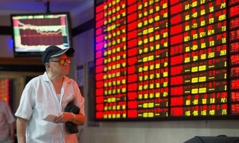 A man watches a screen with share prices in Nanjing, eastern China.