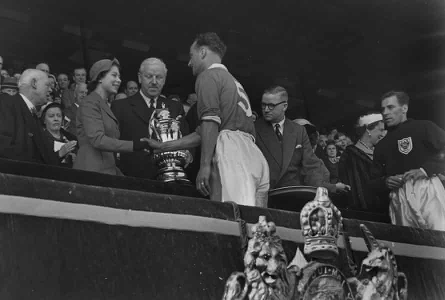 The Blackpool captain, Harry Johnston, shakes the hand of the Queen before receiving the trophy.