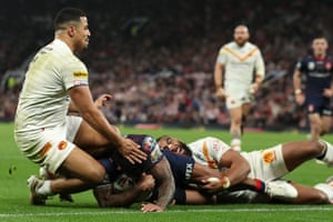 Kevin Naiqama of St Helens crosses for their team’s second try whilst clashing with the knee of Fouad Yaha of Catalans Dragons.
