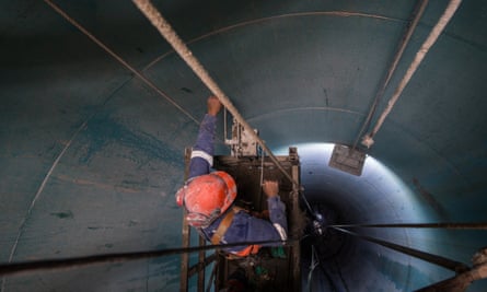 An engineer works on a giant pipe at the Jaguari dam, which will create an 11-mile link to the Cantareira system.