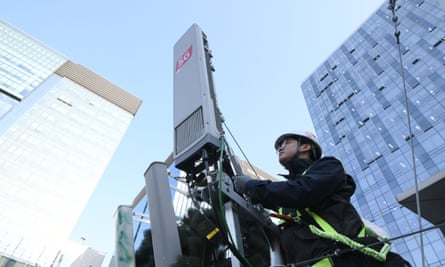 A technician of South Korean telecom operator KT checks an antenna for the 5G mobile network service on the rooftop of a building in Seoul.