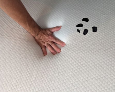 Panda Bamboo Mattress Topper has a simple panda logo. There is a hand pressing down into the mattress topper.