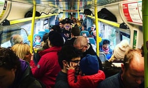 Passengers standing on a Southern rail service into London.