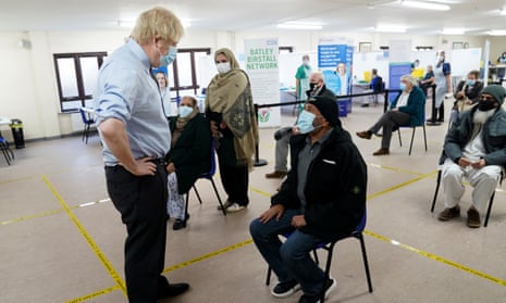 Boris Johnson talks to waiting patients at a Covid vaccination centre in Batley, West Yorkshire.