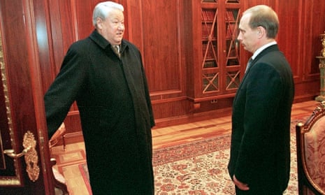 Former president Boris Yeltsin smiles as he holds a door before leaving his study as his successor, Vladimir Putin, listens in the Kremlin, in Moscow 