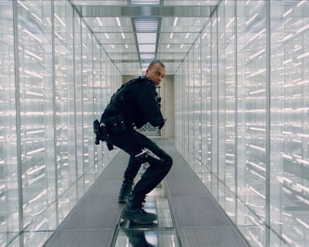 man in narrow glass corridor