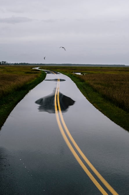 A flooded road cutting through Blackwater National Wildlife Refuge. People plan their schedules around high tide, whether it’s running errands or work. It has even affected the timing of school buses.