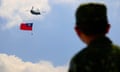 A helicopter carrying Taiwan flag flies over a military camp in 2021.