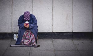A woman is seen begging in London.