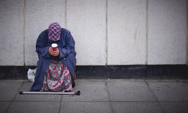 A woman is seen begging in London.