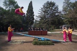 Competitors take part in a see-saw event during the 13th people’s games at Moran Hill park in Pyongyang