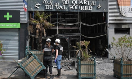 Police examine the facade of a burnt-down annex town hall in the Le Val Fouree area of Mantes-la-Jolie on Wednesday