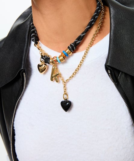 close-up of chunky charm necklaces on woman’s neck