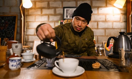 man pours a cup of tea