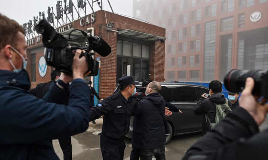 The WHO team arrive at ghe heavily guarded Wuhan Institute of Virology on Wednesday.