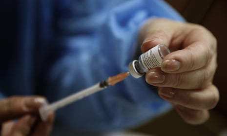 A nurse prepares a Pfizer-BioNTech vaccine to be administered.