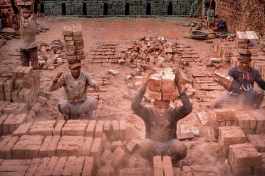 Covered in dust and sweat, labourers in a Narayanganj brickfield balance stacks of bricks on their heads, their bodies bearing the weight of both labour and survival