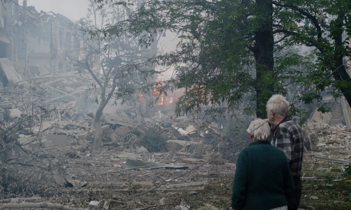 An elderly couple stands near a damaged school after a missile strike hit the city of Kramatorsk, Donetsk region, eastern Ukraine. At least one person was killed after shelling hit the school and two others are feared under the rubble, the Ukrainian State Emergency Service said.
