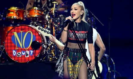 a woman sings on stage