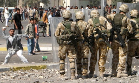 Hearts and minds … a youth hurls a rock a British soldiers during a violent protest by job seekers in Basra, March 2004.
