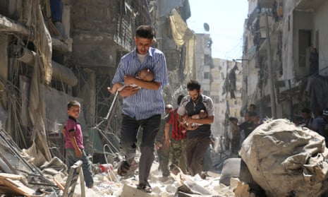 Men carry babies through rubble in Aleppo