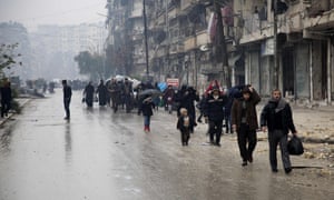 Syrians leave a rebel-held area of Aleppo to go to the government-held side.