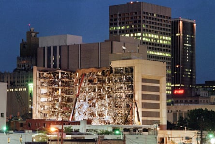 Floodlights illuminate the Albert P. Murrah Federal Building in Oklahoma City 20 April 1995 as rescuers continue searching for bodies in the aftermath of the 19 April explosion caused by a fuel-and fertilizer truck bomb that was detonated early 19 April in front of the building.