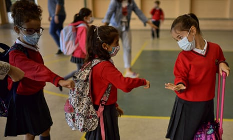 Children wearing face masks enter the Luis Amigó school in Pamplona, Spain, on Monday as students in five regions return to class for the first time in six months.