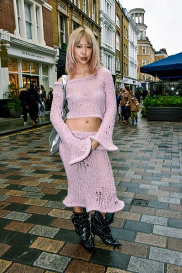 A person wearing a two-piece pink outfit