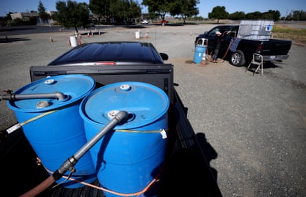A resident fills a water tank with recycled water from a fill station in Oakley.