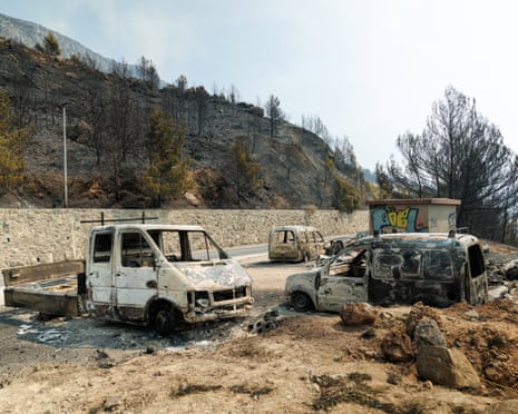Burnt vehicles following wildfire in Stanići, Croatia.