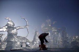 A worker polishes an ice sculpture ahead of the international ice and snow festival in Harbin, China