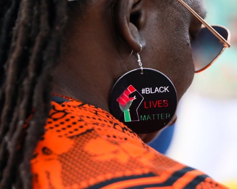 A woman with Black Lives Matter on her earrings 