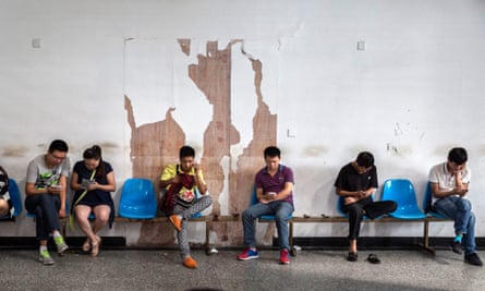 Migrant workers wait at a job centre
