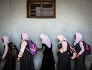 Girls queue for the toilets in Faihaa school