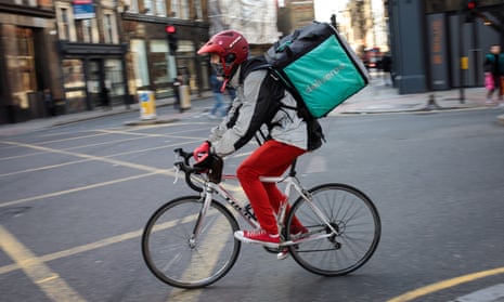 A Deliveroo rider cycles through central London.