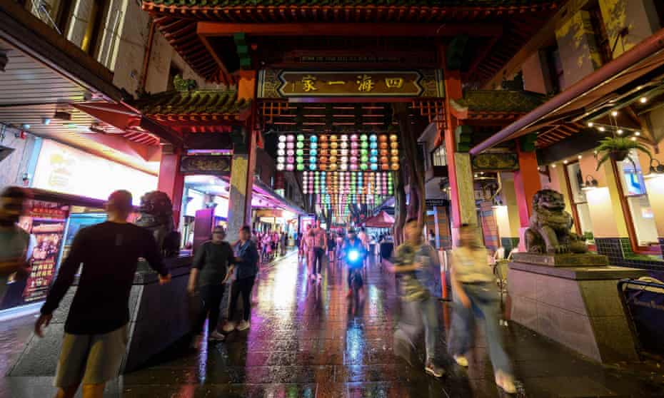 People walk along a street decorated with lanterns during lunar new year celebrations in Sydney