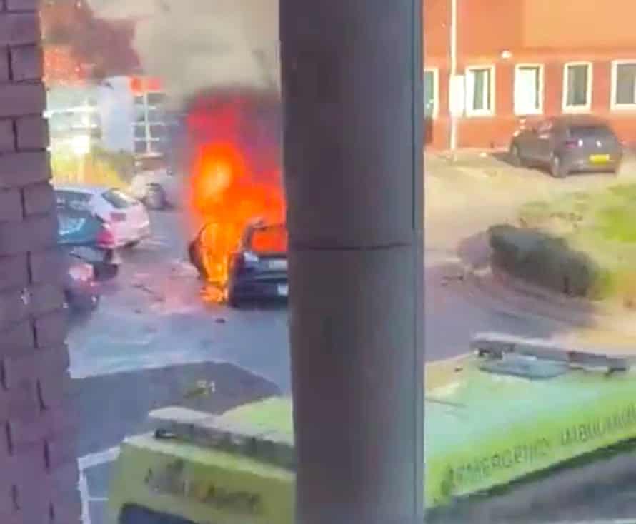 The vehicle on fire outside the hospital.