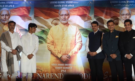 Bollywood stars pose with posters for the film PM Narendra Modi