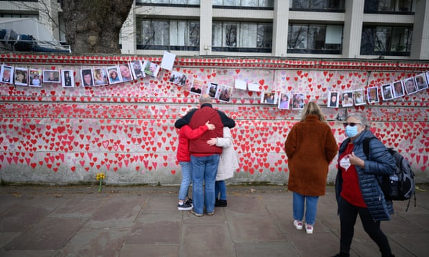 Mourners and visitors at the Covid memorial wall in London.